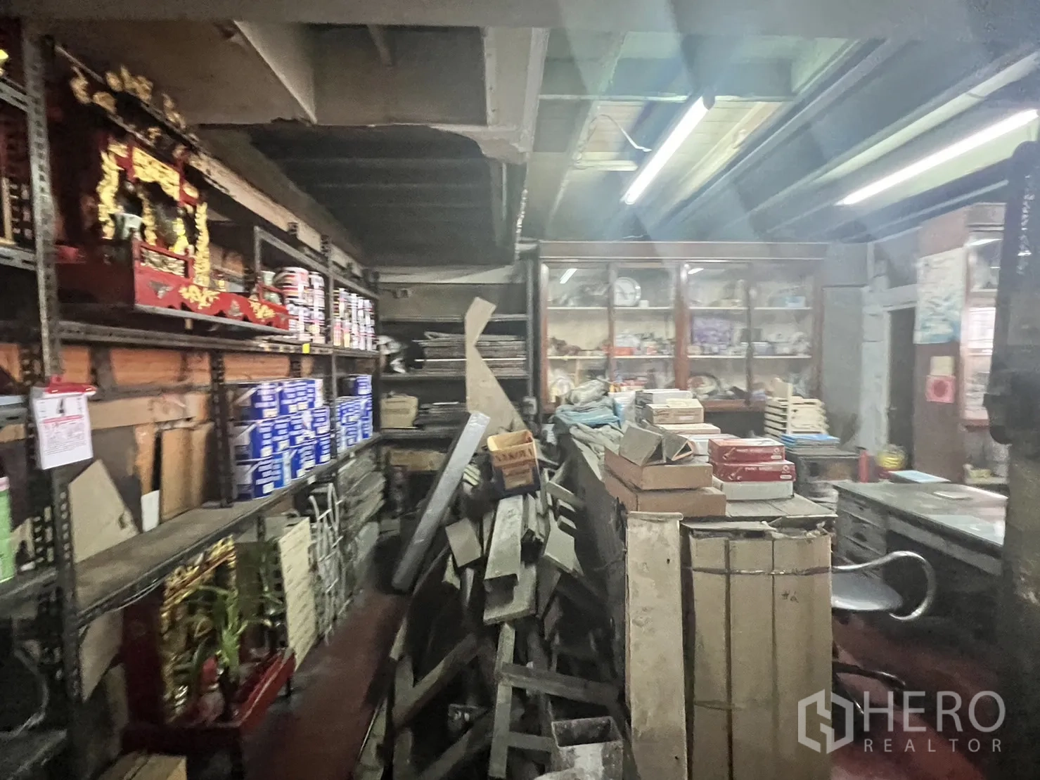 Retail Space for rent in Watthana, Bangkok - Rear storage area with stacked timber, metal racking and paint tins in a workshop-style space.