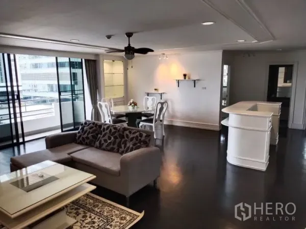 Condominium for rent in Sathon, Bangkok - Spacious open-plan living and dining area with a ceiling fan and sliding doors to a balcony.