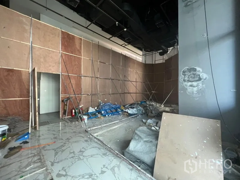 Retail Space for rent in Sathon, Bangkok - Retail space under renovation with marble-look flooring and temporary partition walls.