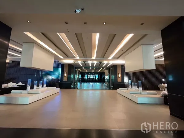 Condominium for rent in Sathon, Bangkok - Modern condominium lobby featuring recessed lighting and white lounge seating.