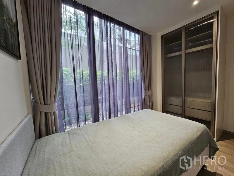 Condominium for rent or sale - Second bedroom with floor-to-ceiling windows and sliding-door wardrobe.