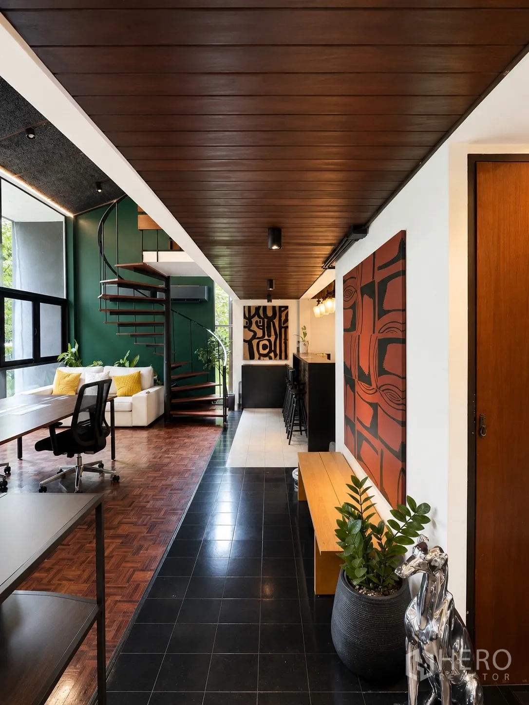 Office Space for rent in Phaya Thai, Bangkok - Entrance hall with bench, plants, artwork, and view to bar and spiral staircase.