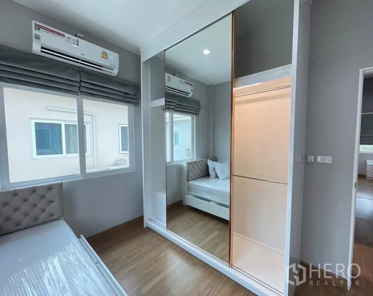 Detached House for rent in Bang Khen, Bangkok - Bedroom showing mirrored sliding wardrobe and air conditioning.