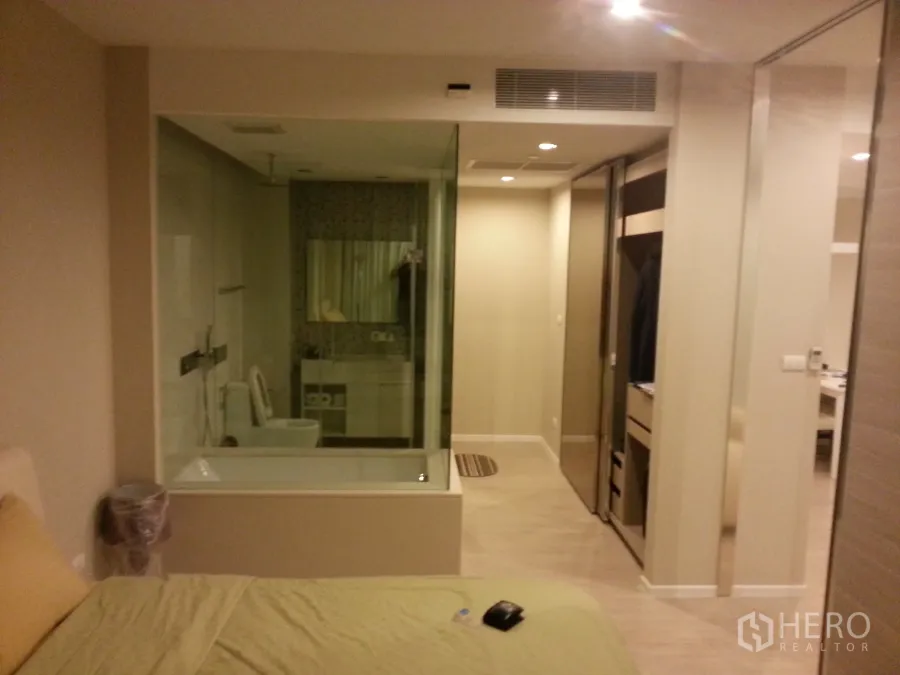 คอนโด ให้เช่าหรือขายในWatthana, Bangkok - ห้องนอนพร้อมห้องน้ำผนังกระจก อ่างอาบน้ำ และตู้เสื้อผ้าบิลท์อิน ที่ The Room สุขุมวิท 21