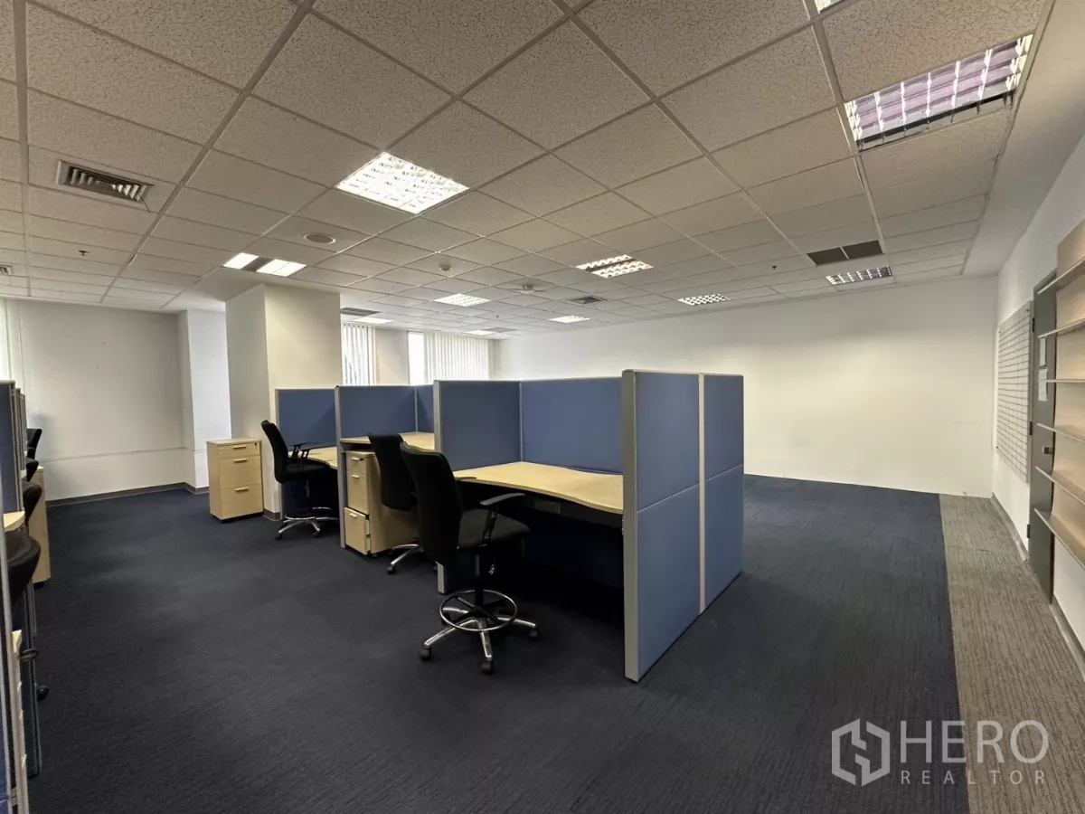 Office Space for rent in Watthana, Bangkok - Corner view of cubicle clusters with dark carpet and bright walls.