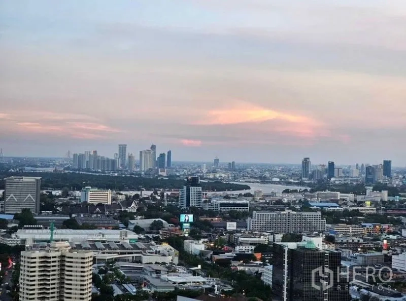 Condominium for rent or sale - High-floor balcony view over Bangkok skyline at dusk.