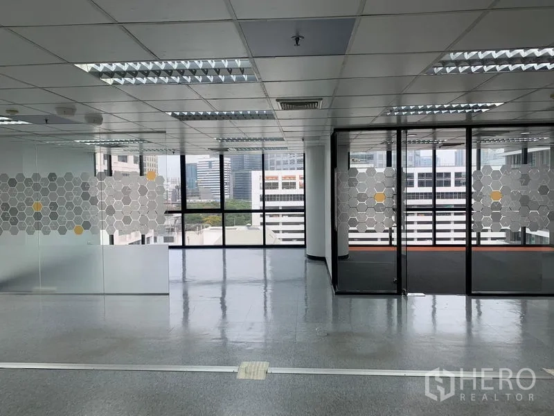 Office Space for rent in Bang Rak, Bangkok - Open-plan office with glass-partitioned meeting rooms and city skyline views.
