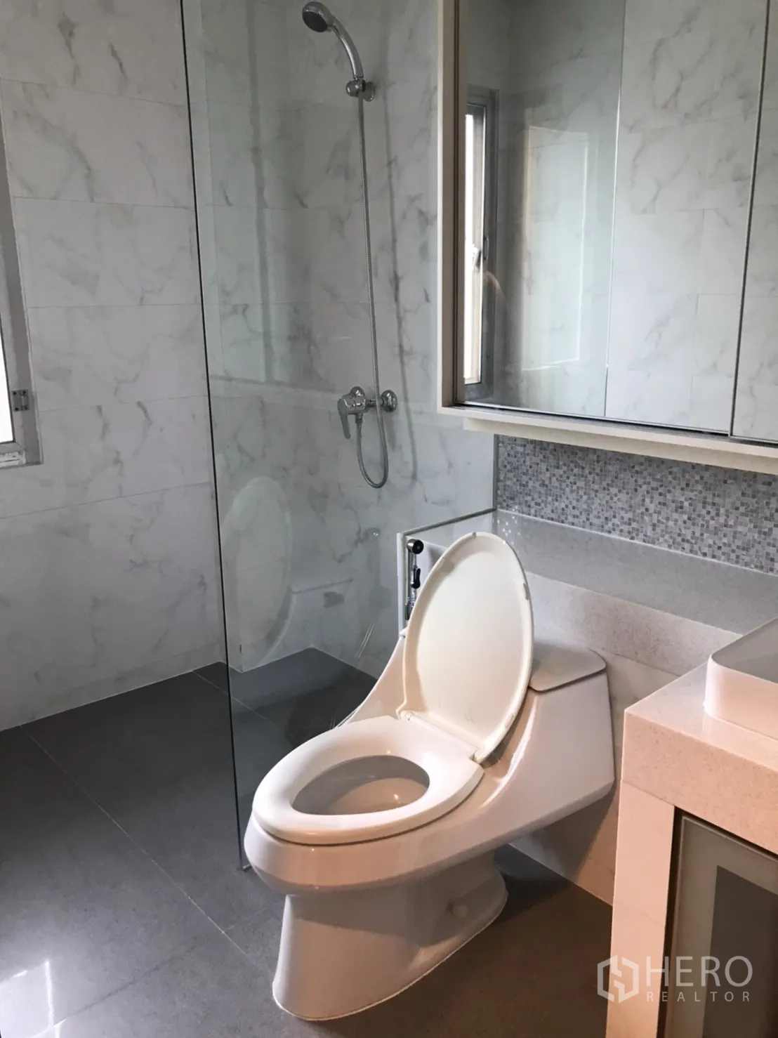 Detached House for rent in Wang Thonglang, Bangkok - Bathroom with glass shower enclosure, large mirror and toilet