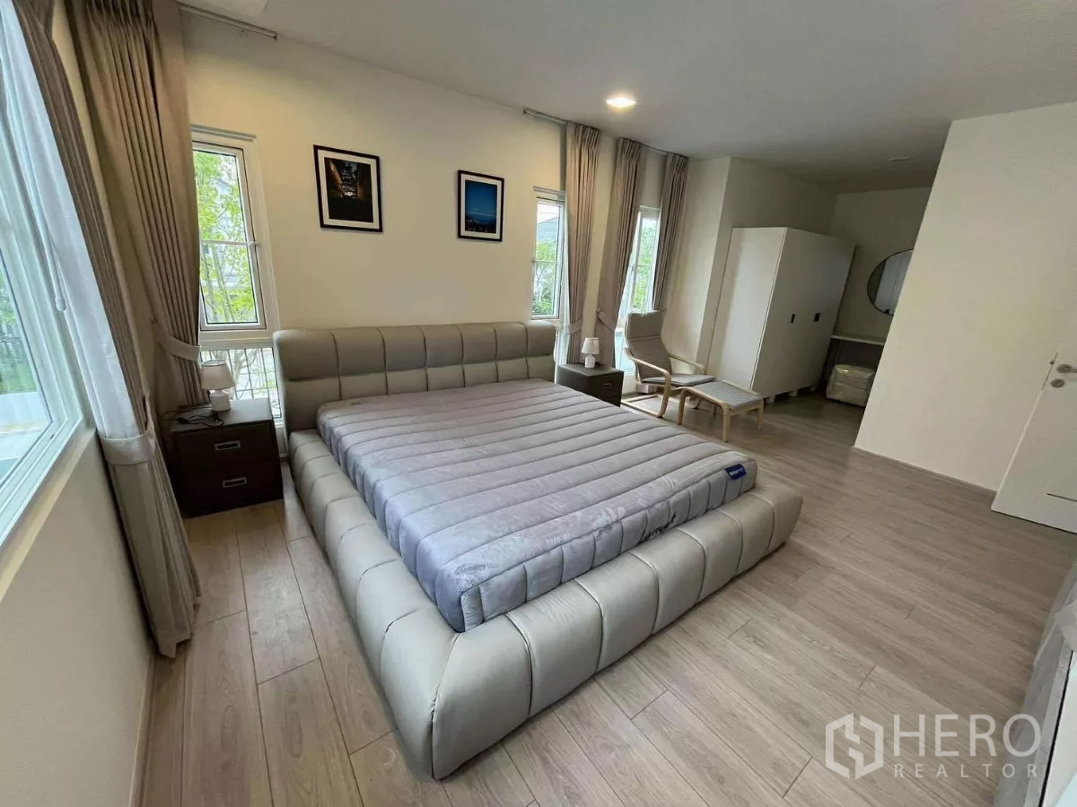 Detached House for rent in Bang Phli, Samut Prakan - Master suite angle showing wardrobe, seating nook, and natural light.