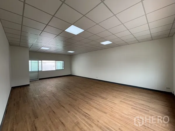 Retail Space for rent - Spacious rectangular retail unit with LED panel ceiling and a wide side window.