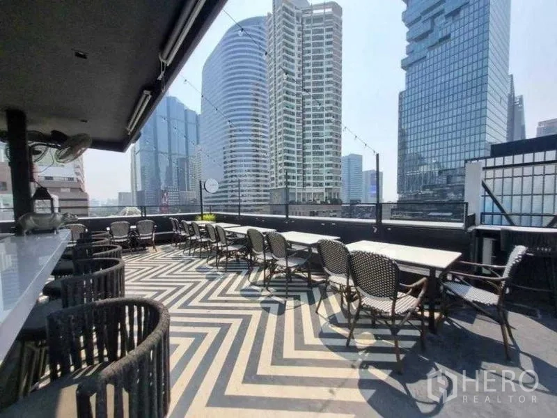 Retail Space for rent in Bang Rak, Bangkok - Rooftop terrace with patterned floor, dining tables and Bangkok skyline views.