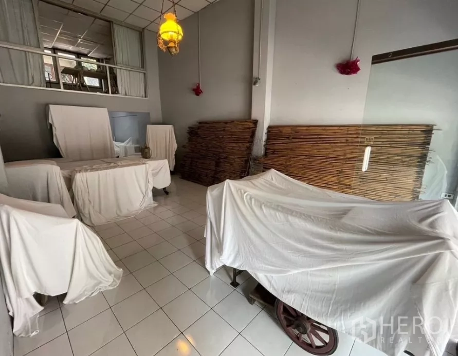 店屋 出租在Watthana, Bangkok - 店内房间有覆盖布套的展示车、吊灯及竹制隔断。