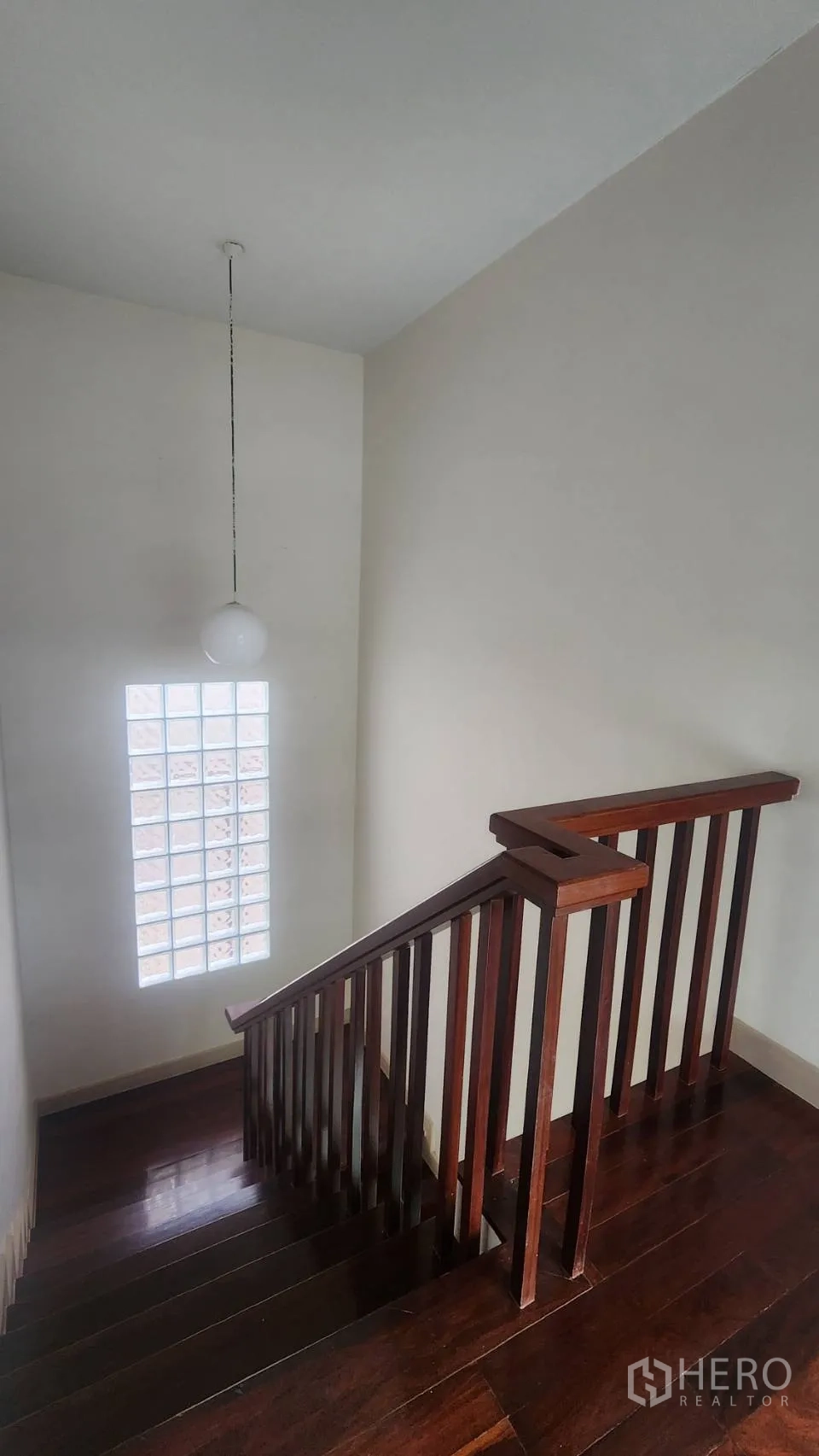 Detached House for rent in Watthana, Bangkok - Wood staircase with glass-block window and pendant light.