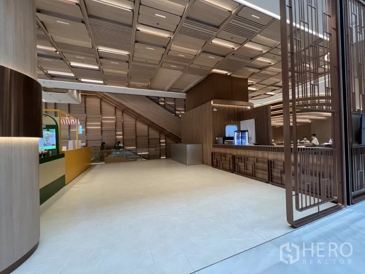 Retail Space for rent - Open retail hall with tiled flooring, wide frontage and beverage counter nearby