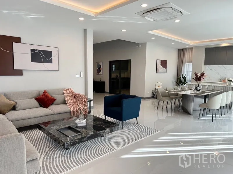 Detached House for rent or sale in Bang Phli, Samut Prakan - Open living-dining layout showing lounge and long dining table.