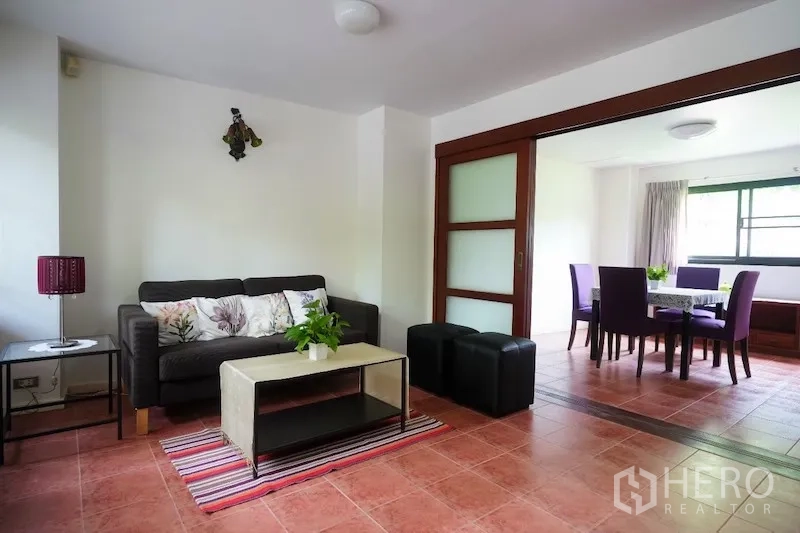 Detached House for rent in Chatuchak, Bangkok - Separate lounge with terracotta tiles, sliding doors, and adjacent dining room.