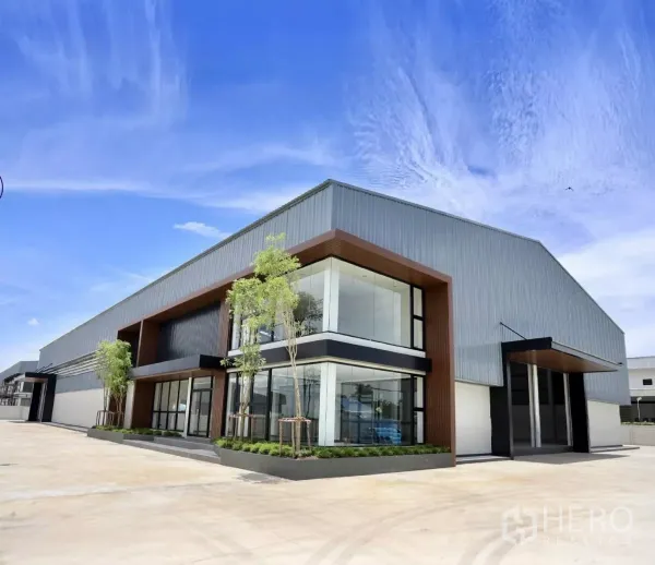 Factory for rent or sale in Phutthamonthon, Nakhon Pathom - Modern factory exterior with a two-storey glass-front office and wide concrete yard in Phutthamonthon.