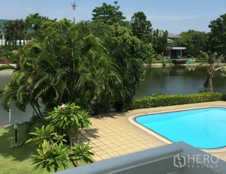 Detached House for rent in Bang Phli, Samut Prakan - Balcony outlook across a private pool toward palm trees and a tranquil lake.