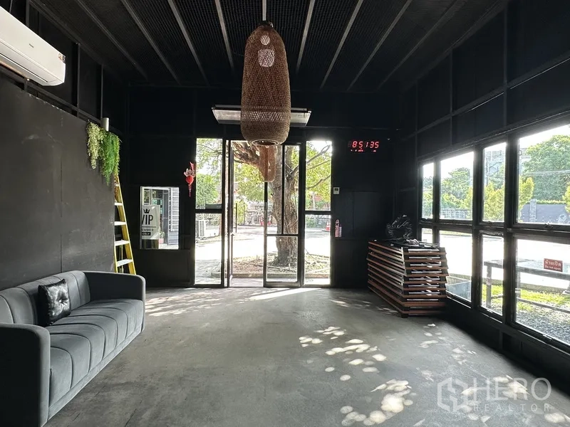 Retail Space for rent in Phra Khanong, Bangkok - Lobby-style space with sofa, glass door, large windows and woven pendant.