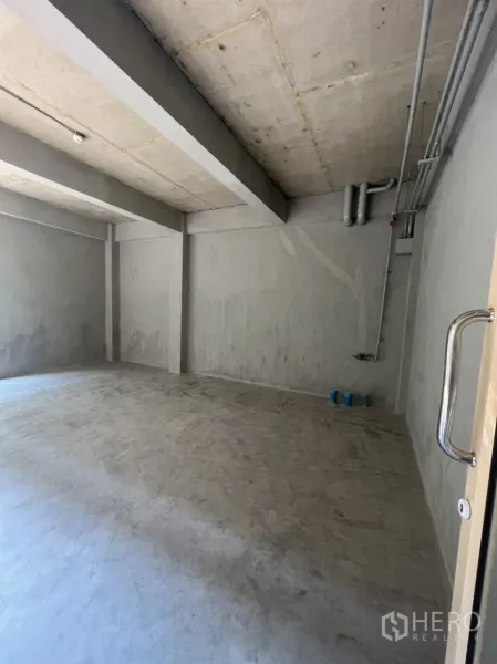 Retail Space for rent in Watthana, Bangkok - Empty shop interior viewed from the entrance with concrete floor and exposed ceiling services.