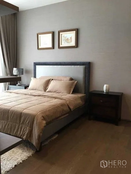 Condominium for rent in Bang Rak, Bangkok - Bright bedroom with upholstered bed, nightstands, and a large window with curtains.