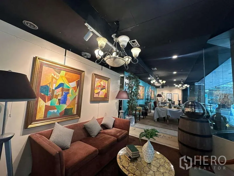 Retail Space for rent - Front display lounge with glass frontage, chandeliers, artwork and sofa seating.