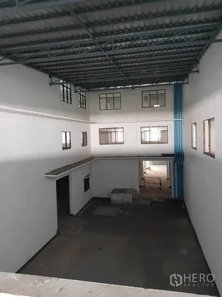 Warehouse for rent in Nong Khaem, Bangkok - High atrium space with corrugated metal roof and interior windows.