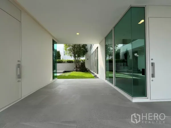 Detached House for sale in Bang Phli, Samut Prakan - Covered entry corridor with large glass panels opening to a small lawn