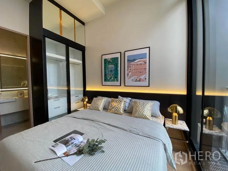 คอนโด ให้เช่าในWatthana, Bangkok - ห้องนอนหลักพร้อมตู้เสื้อผ้าบิลท์อิน ไฟตกแต่งโทนอุ่น และโคมข้างเตียง