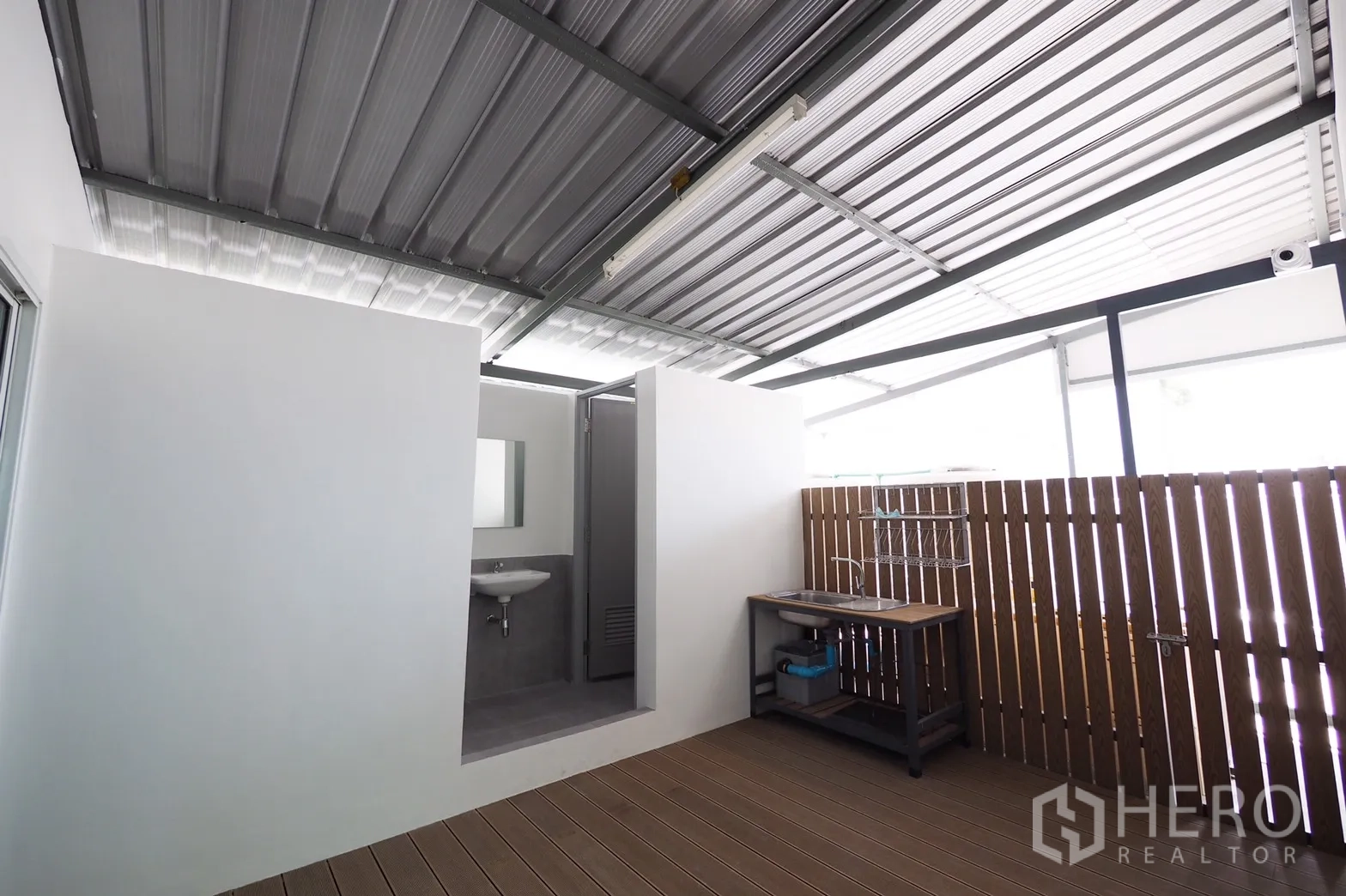 Office Space for rent in Khlong Toei, Bangkok - Covered utility terrace with stainless sink, wood privacy screen and access to restroom.