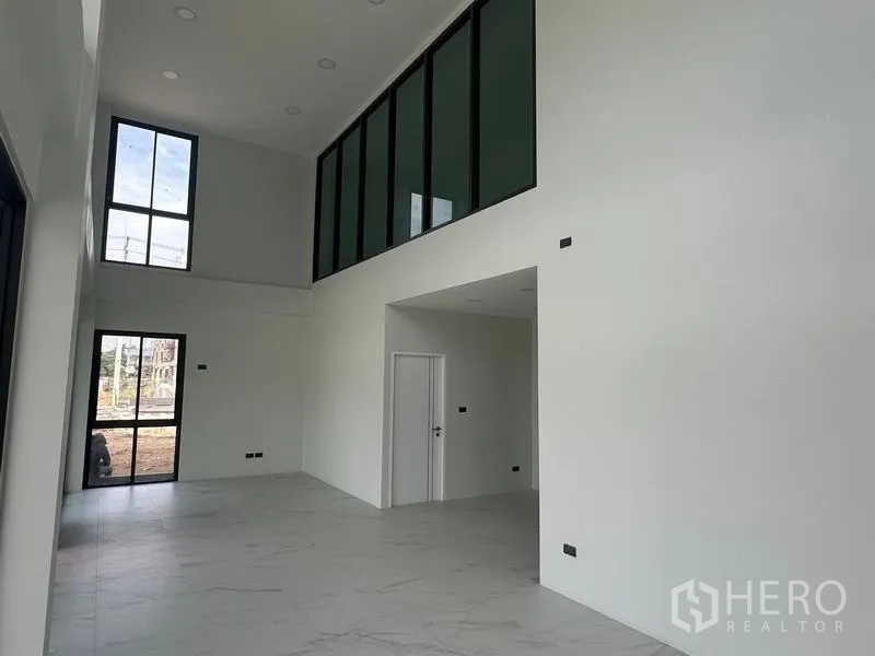 Warehouse for sale in Lam Luk Ka, Pathum Thani - Bright reception space with high ceiling, tall windows and entry door.
