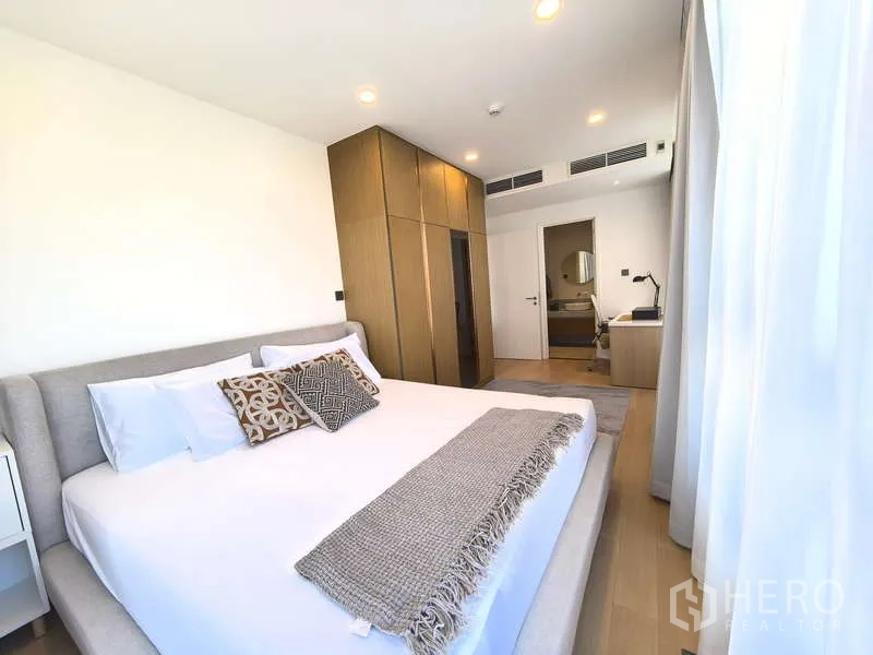 Apartment for rent - Master bedroom looking toward ensuite and built-in wardrobes in the Watthana apartment.