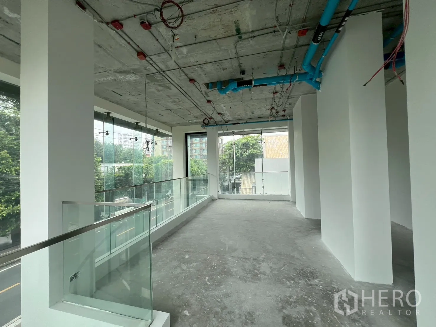 Retail Space for rent - Bright mezzanine level with glass balustrade and exposed ceiling services.