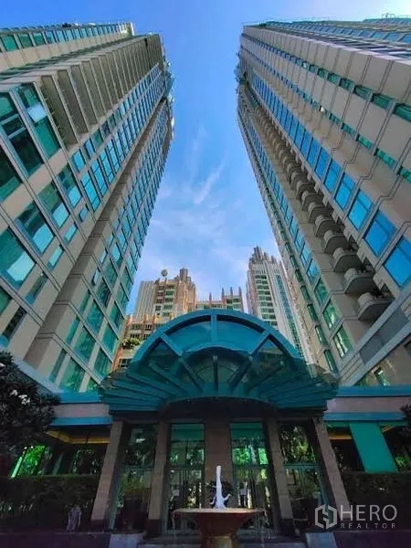 公寓 出租在Pathum Wan, Bangkok - The Park Chidlom双塔外立面，玻璃雨棚入口与喷泉。