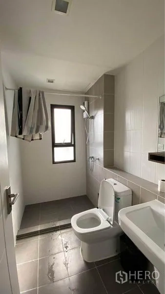 Retail Space for sale in Bang Na, Bangkok - Clean bathroom with separate shower zone, window and white fixtures.