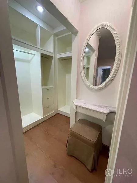 Condominium for rent - Walk-in closet with dressing table, mirror and built-in wardrobes.