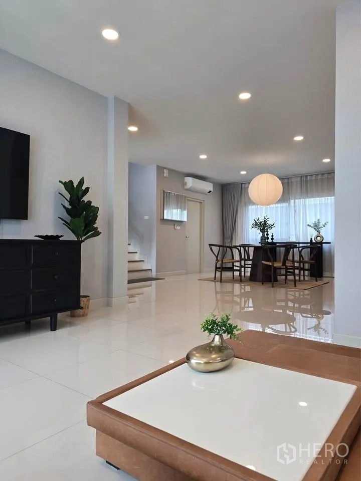 Detached House for rent or sale in Bang Phli, Samut Prakan - Open-plan living and dining space with staircase and glossy floors.