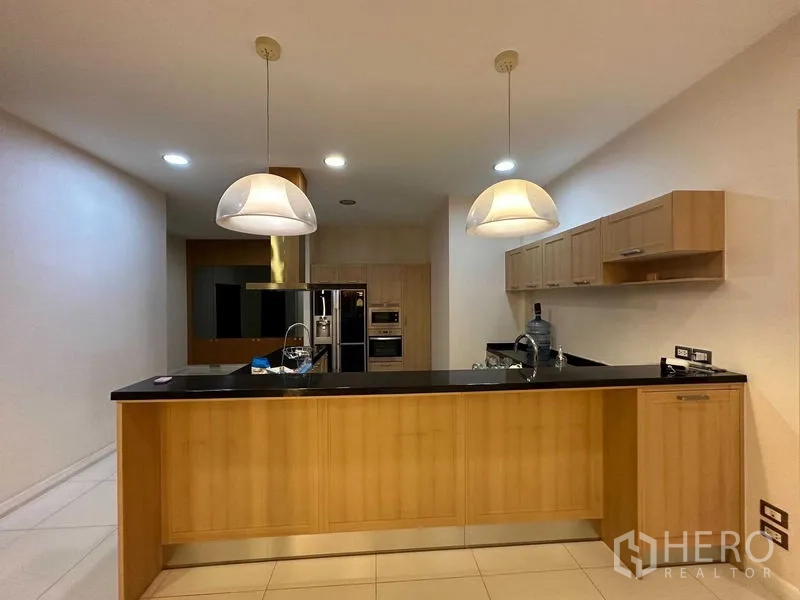 Detached House for rent or sale in Bang Phli, Samut Prakan - Modern kitchen with island, light wood cabinetry and pendant lights
