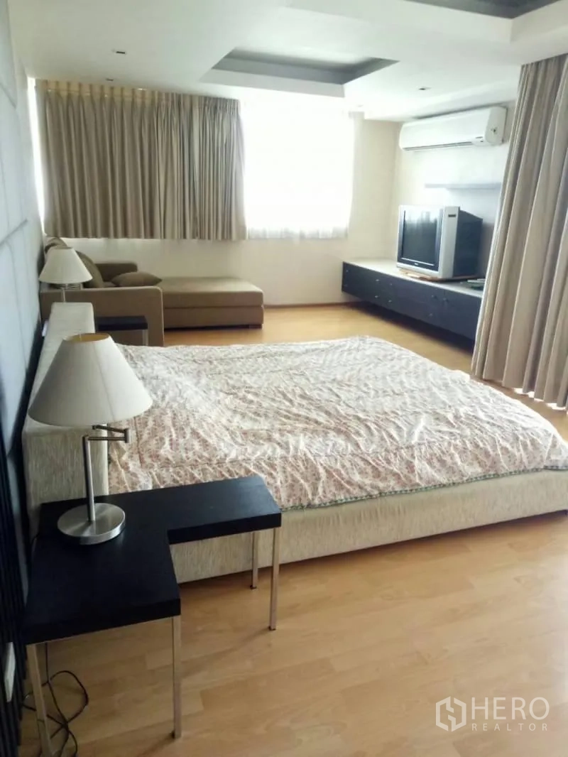 公寓 出租在Watthana, Bangkok - 明亮卧室，特大床、床头柜、贵妃椅沙发与电视柜，大窗采光好。
