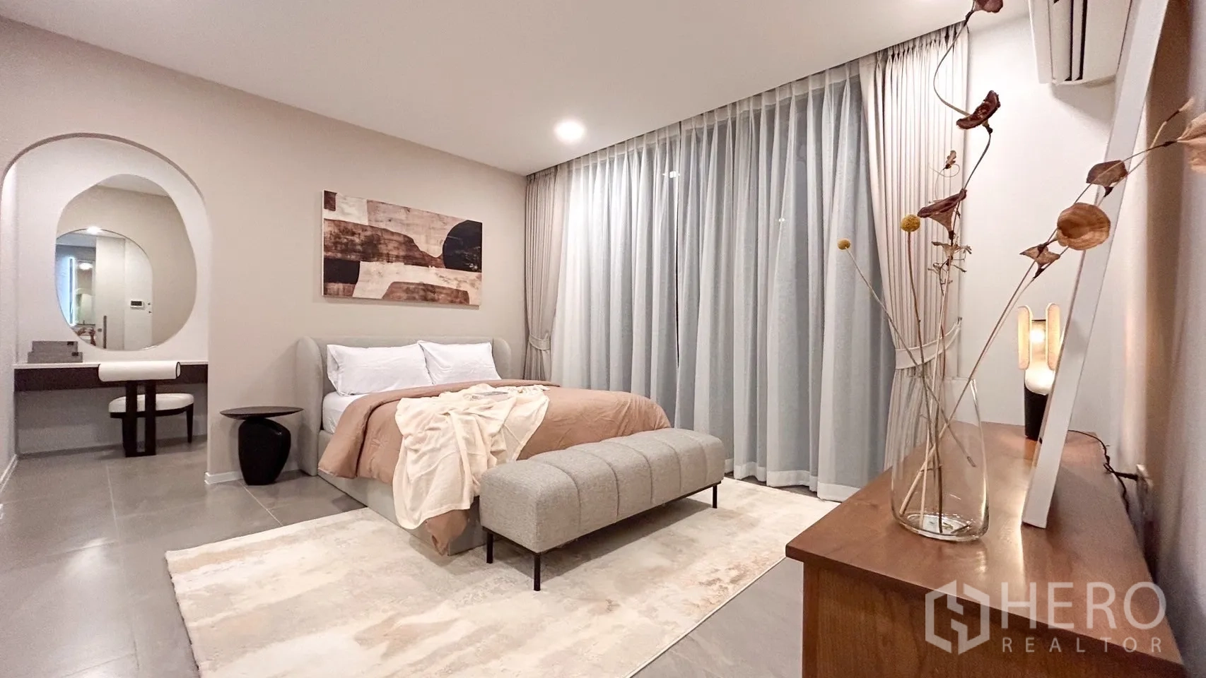 Detached House for rent in Saphan Sung, Bangkok - Primary bedroom with vanity alcove, soft drapes and upholstered bench.