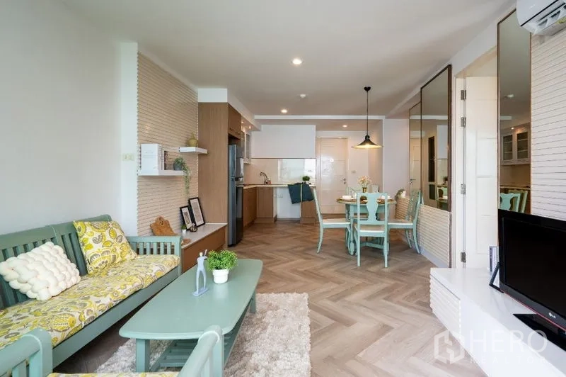 公寓 出售在Watthana, Bangkok - 明亮的客餐厅，薄荷色家具、开放式厨房与鱼骨拼地板。