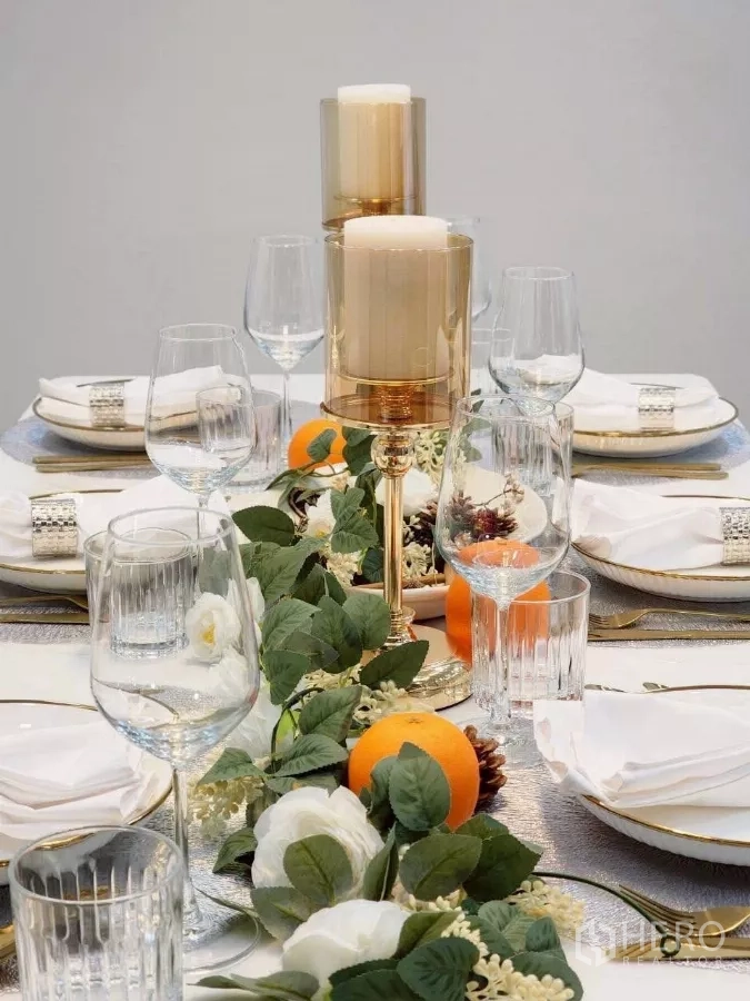 Townhouse for rent in Huai Khwang, Bangkok - Close-up of elegant dining setup with candles, glassware and greenery centerpiece.