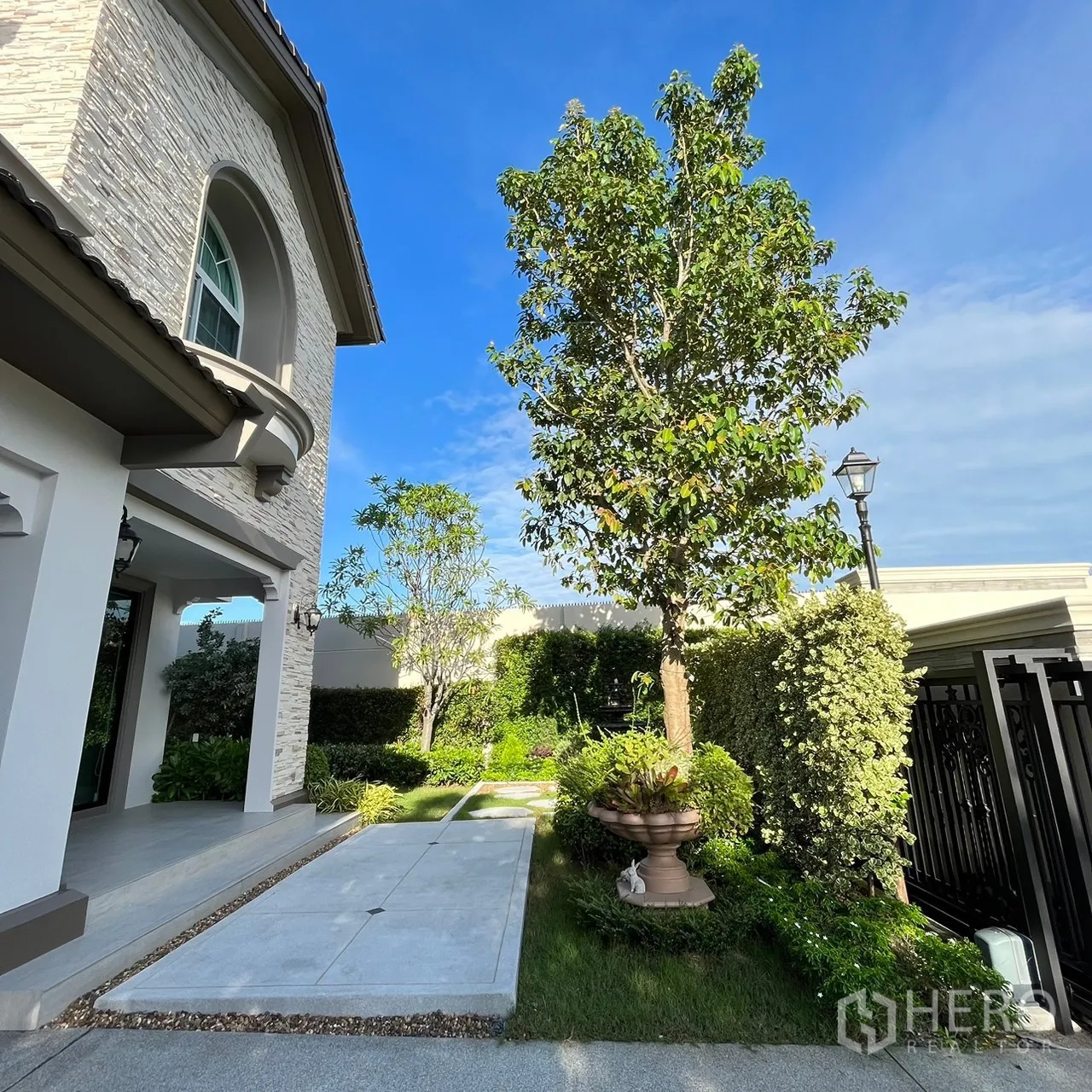 Detached House for rent or sale in Bang Khen, Bangkok - Front garden with landscaped walkway and stone‑clad façade.