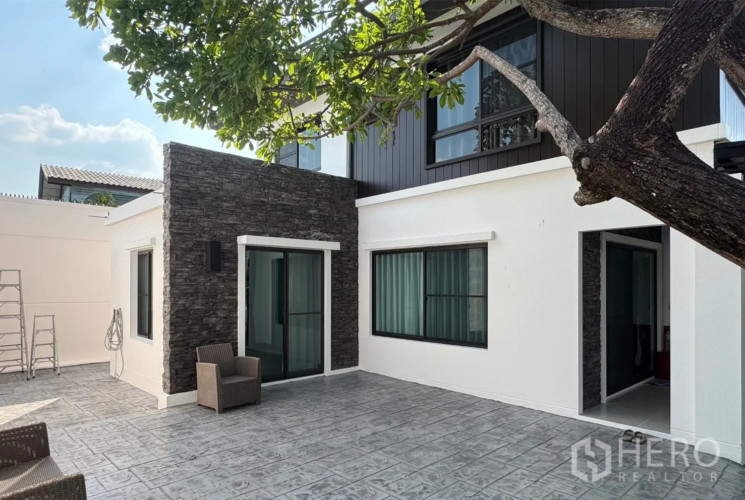 บ้าน for rent in Bang Phli, Samut Prakan - ลานกว้างภายนอกพร้อมผนังหินตกแต่งและประตูกระจกหลายจุด