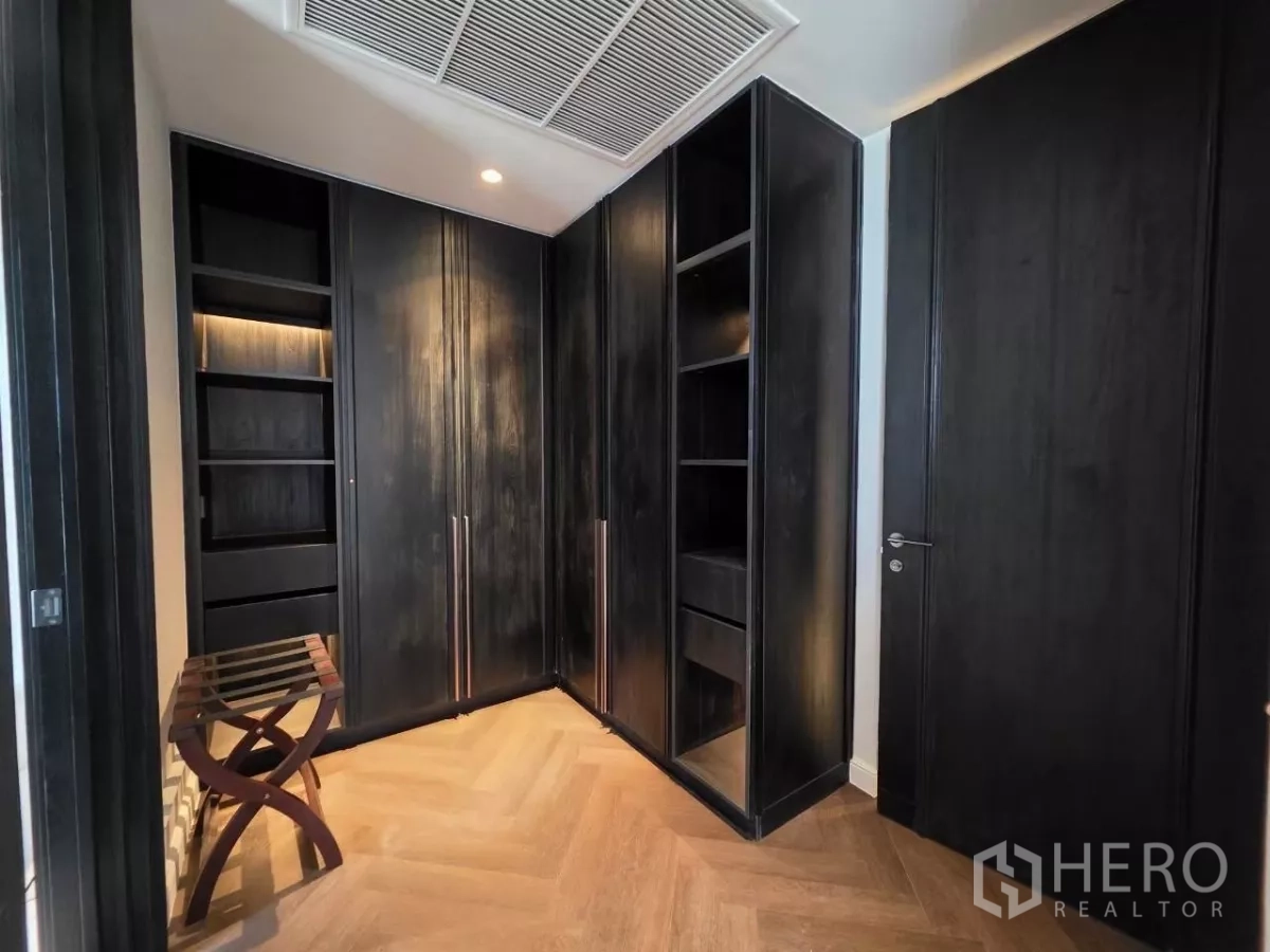 Condominium for rent - Bedroom corner with built-in wardrobe and large wall mirror.