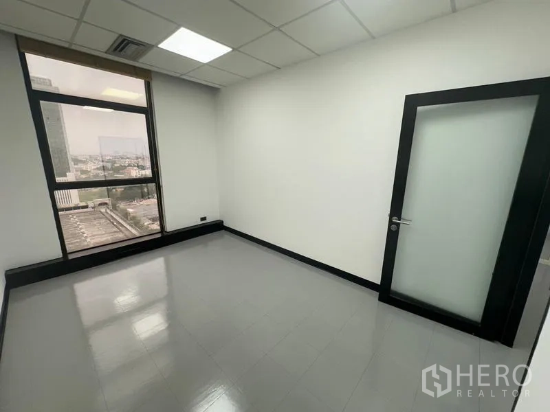 Office Space for rent - Private room with frosted glass door and large window facing the skyline.