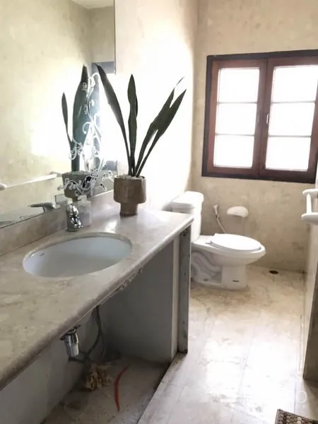 Detached House for rent in Phra Khanong, Bangkok - Bathroom with a large mirror, stone countertop sink, and a window for natural light.