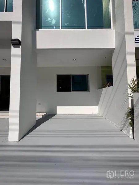 Home Office for sale in Lat Krabang, Bangkok - Covered carport area beneath the building with window and recessed lighting.