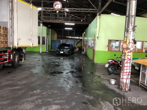 Warehouse for rent in Bang Kho Laem, Bangkok - Covered loading bay inside the warehouse with a truck, concrete floor and internal office units.