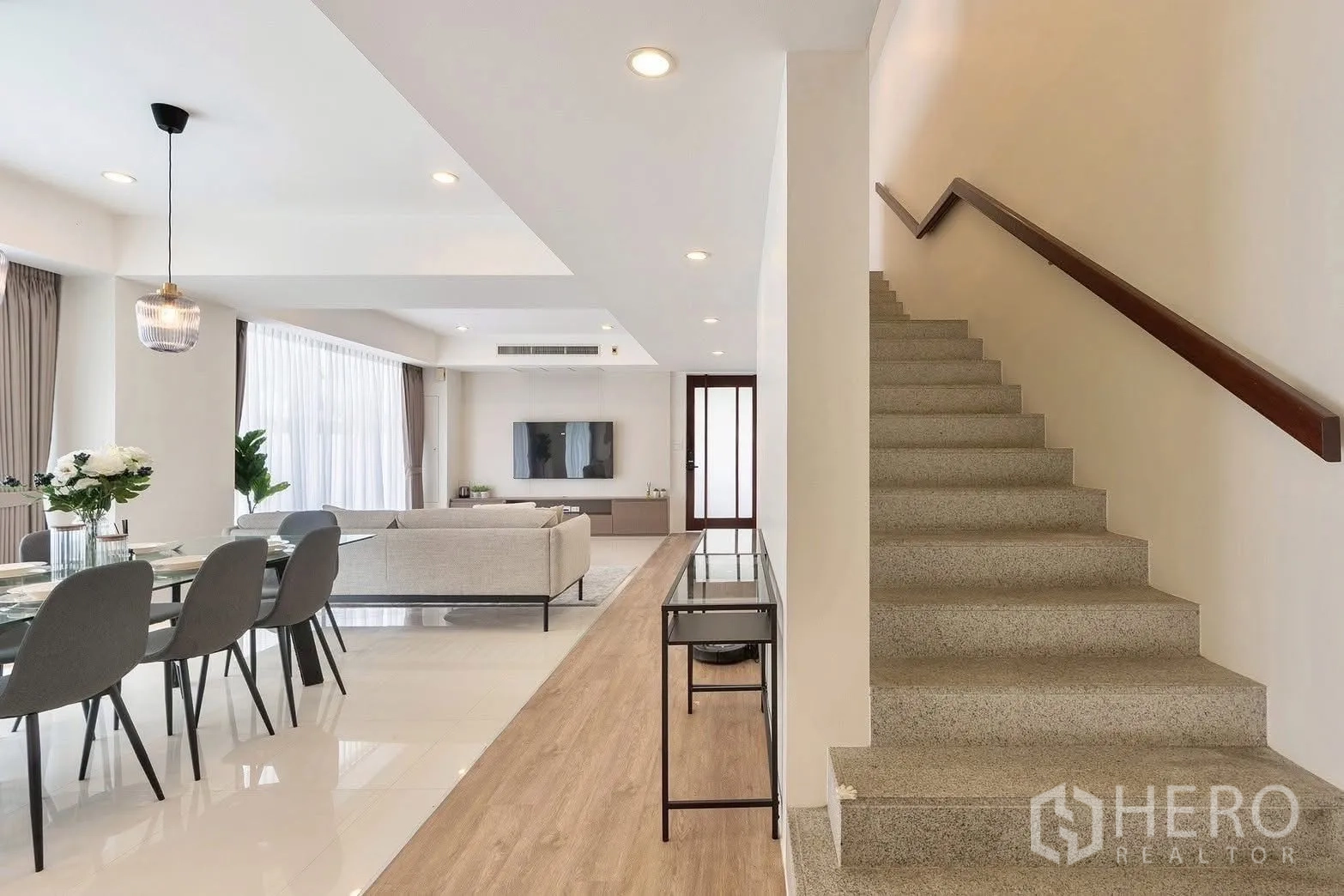 Detached House for rent in Saphan Sung, Bangkok - Open-plan living and dining area with staircase and recessed lighting.